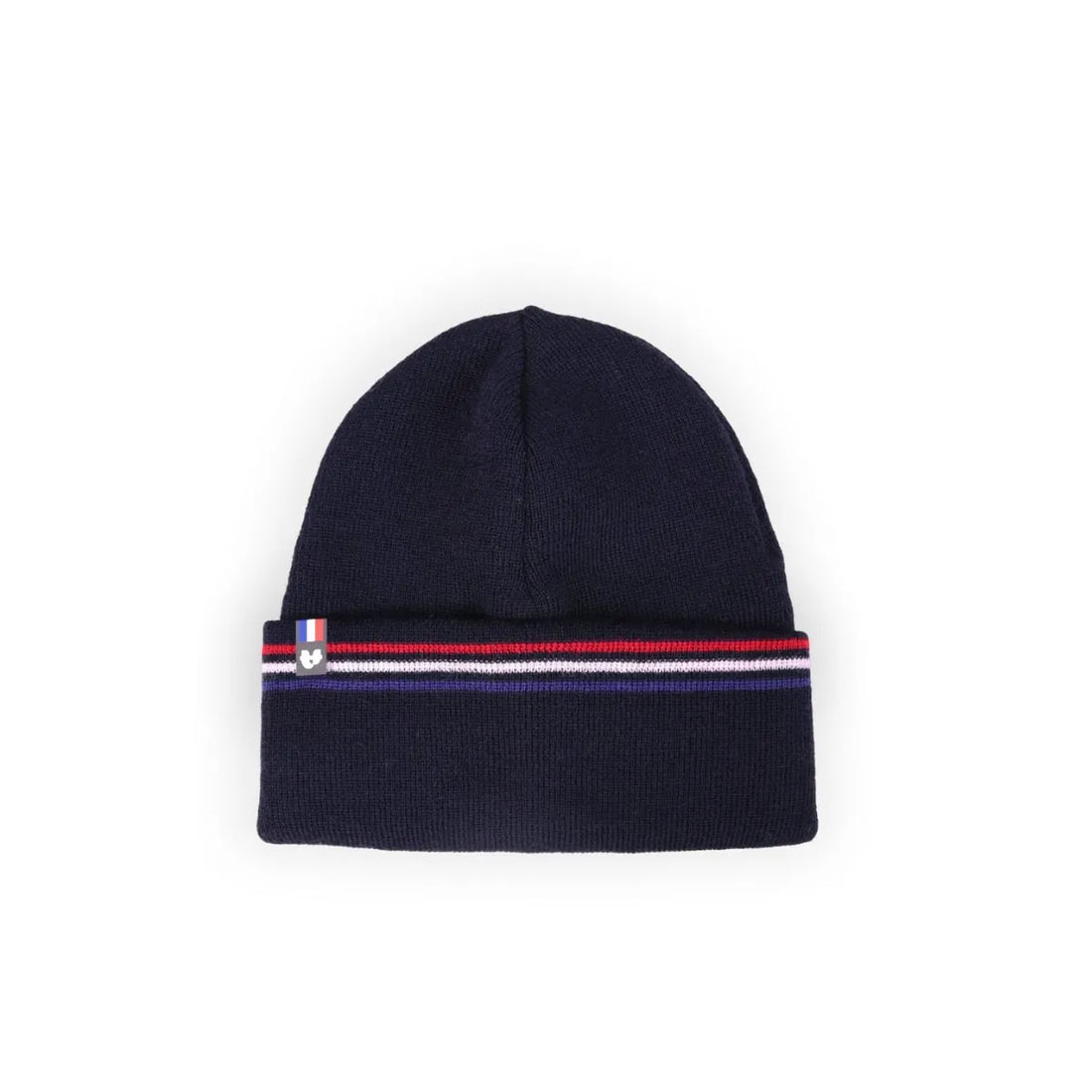 Femme souriante portant un bonnet en laine bleu marine à revers rayé bleu-blanc-rouge, manteau marine, dans les dunes – PALÂBA