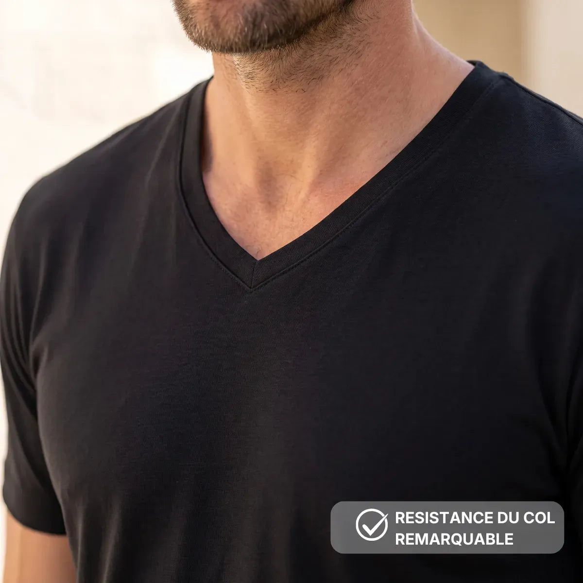 Détail du col V du t-shirt homme noir en coton bio, finition nette et surpiqûres – PALÂBA